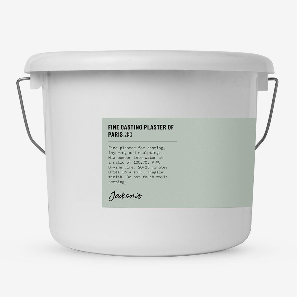 White container with green label for fine casting plaster of Paris on a white background