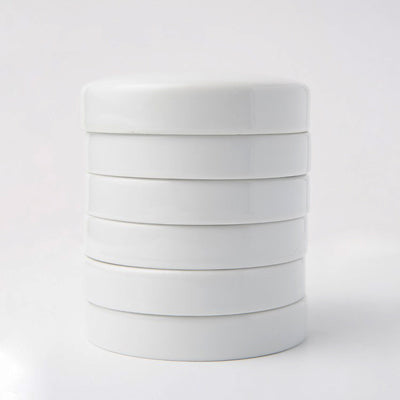 This is a stack of five ceramic colour mixing trays with a lid.